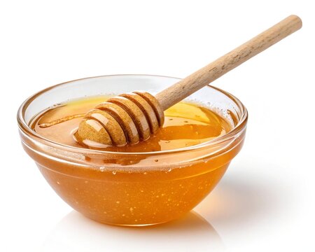 Honey in glass bowl with wooden dipper