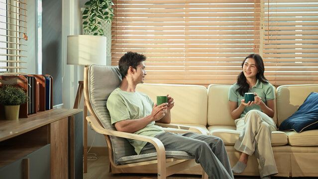 Young couple relax in living room with hot coffee