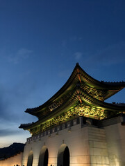 Illuminated Traditional Korean Gate Against the Evening Sky

