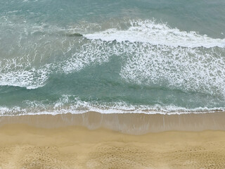 Aerial Top View of Beach Waves Rolling Over Sand