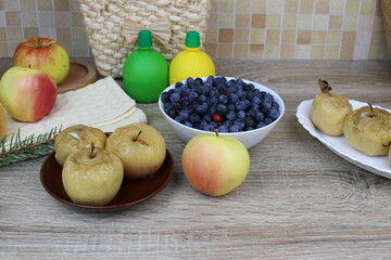 baked apples on the table and a full plate of sloes