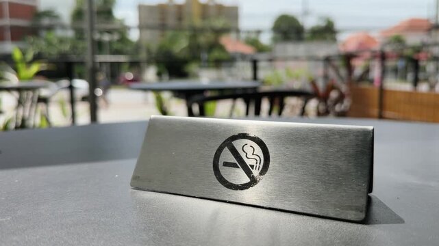 No smoking sign on sunlit cafe table symbolizing healthy choices and clean air policy