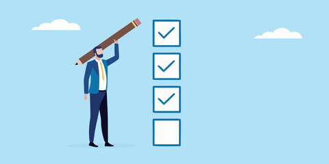 Businessman completing a checklist with a large pencil