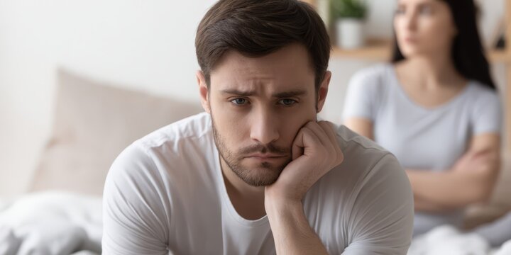 Upset man feeling sad after relationship conflict with woman