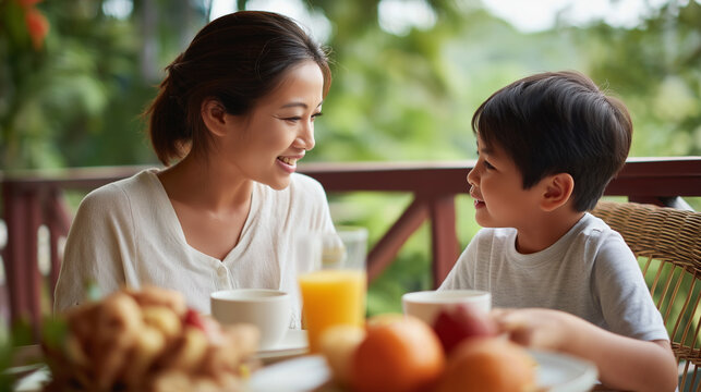 Parent and youngster enjoying breakfast on balcony faceless mother son defocused outdoor background peaceful sharing moment morning meal scene family connection visualization