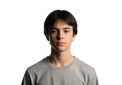 A portrait of a young man in a simple setting with a , boy, face, gray, man, portrait, pose, shirt, stand, stare 