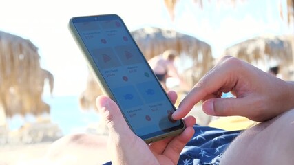 Capture the essence of modern leisure with this shot of a person ordering food on a sunny beach. This video perfectly illustrates the concepts of convenience, instant gratification, and the on-demand