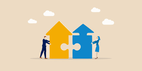 Business partners connecting puzzle pieces to build a house