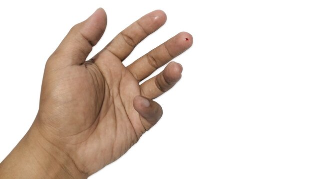 Blood drop on middle finger tip for diagnostic testing or minor injury. Isolated image against a white background.