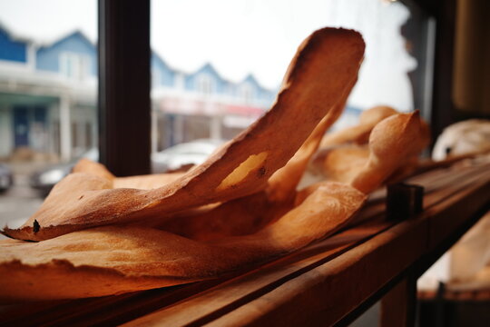 Freshly baked crispy lavash from a tandoor on a bakery counter