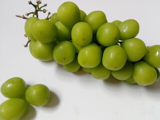 green grapes. close-up of fresh green grapes on white background.