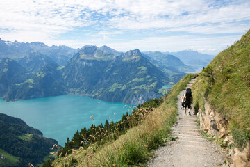 Hiking trail in the high mountains with azure lake view