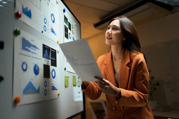 Businesswoman analyzing data charts for strategy planning