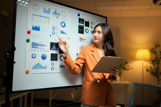 Business professional analyzing financial data on presentation board