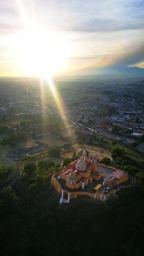 Aerial drone view of the Great Pyramid and Church of Our Lady of Remedies in Cholula, Mexico. Vertical