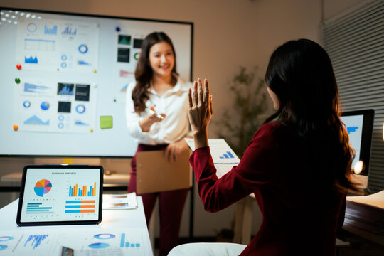 Businesswomen collaborating on data analysis during office meeting