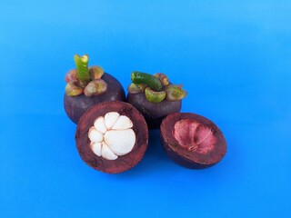 Ripe mangosteen fruit on a blue background