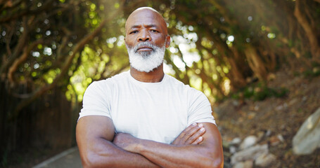 Arms crossed, fitness and portrait of black man in nature for runner, confidence or health....