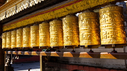 Gold tibetan prayer wheels made from metal at Swayambhunath Temple - Monkey Temple, Kathmandu, Nepal