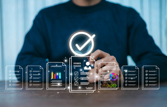 A person reviewing digital documents and data charts with a highlighted checkmark symbol represents workflow approval, data verification, business analysis, and efficient digital document management.