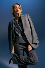 Fototapeta premium Blonde young woman in stylish business attire showcasing modern office fashion