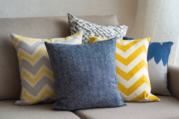 Colorful throw pillows on a beige couch