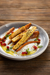 Close up of roasted carrot and parsnip yogurt  wooden surface healthy food