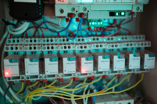 Exploring the intricate wiring of a control panel during an evening maintenance check