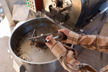 Close-up of farmers roasting coffee beans