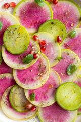 Fresh salad with sliced watermelon radish top view