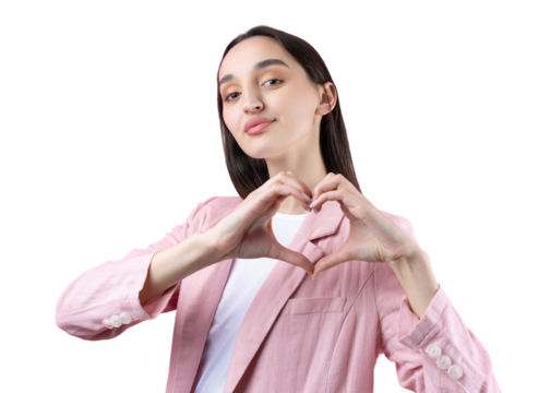 Portrait of a smiling young woman showing heart gesture with her fingers isolated over pikn background