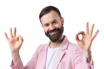 Portrait of a smiling young man in a pink jacket. Man showing ok gesture while standing in studio over isolated red background.