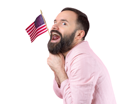 Portrait of a satisfied young man with a beard with an American flag on a red studio background. Great US patriot and defender of freedom.