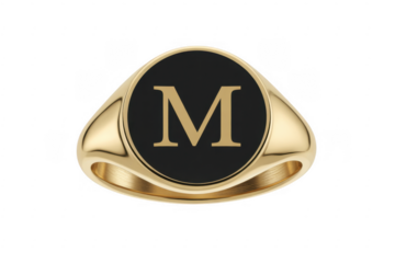 Gold signet ring with black enamel and gold letter M isolated on a transparent background