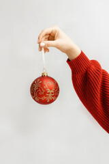 hand holding Christmas tree ornament