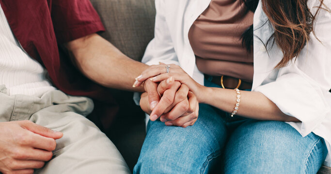 Home, holding hands and couple on sofa, love and bonding together with empathy. Apartment, man and woman on couch, sympathy and trust with compassion, relax and marriage with commitment and support - Powered by Adobe