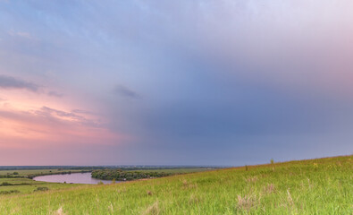 Beautiful sunset over a field with a river in the background