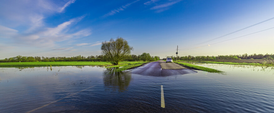 Car is driving down a flooded road