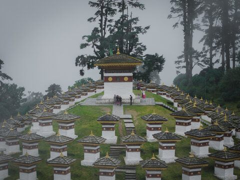 Aerial view of the Dochula Chorten's 108 memorial stupas standing proudly amidst a misty landscape, Dochula pass, Hungtso, Bhutan.