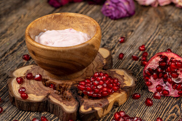 delicious fresh pink yogurt and ripe red pomegranate , delicious pomegranate-flavored yogurt and fresh ripe red pomegranate
