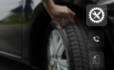 Car Service concept and technology on virtual screen, Serviceman working onsite use tablet check service cycle for maintenance of car .Close up a man checks the tires