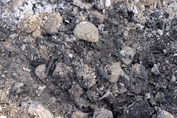 burnt coals from logs with a lot of dust , dust and burnt coals after cooking meat in the grill