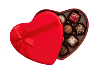 A red heart-shaped box filled with chocolates, with a red ribbon bow on top.