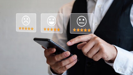 Rate your experience now! Businessman gives feedback with a mobile app, using a five-star rating system for customer satisfaction and business evaluation