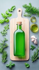 A green glass bottle with a cork stopper sits on a wooden cutting board, surrounded by fresh herbs like rosemary, basil, and mint, along with a bulb of garlic a