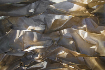 Crumpled white fabric as a background, closeup of photo