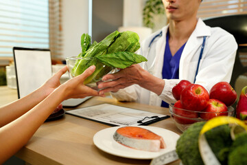 Nutritionist giving consultation to patient with healthy fruit and vegetable, Right nutrition and diet concept