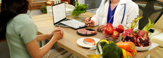 The healthcare professional providing nutritional guidance to a patient, developing healthy diet,...