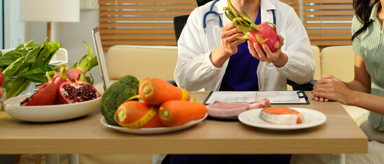 Dietician, male nutrition specialist consulting woman, developing healthy diet, dietary program. Dietary consultant asking, giving male patient advice, help, nutritional information, new meal plan