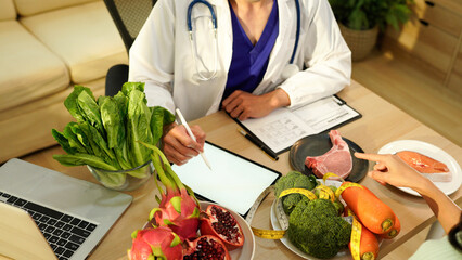 Dietician, male nutrition specialist consulting woman, developing healthy diet, dietary program. Dietary consultant asking, giving male patient advice, help, nutritional information, new meal plan